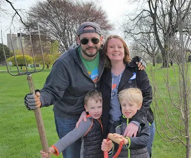 Robb Drzewicki and his family planting a tree